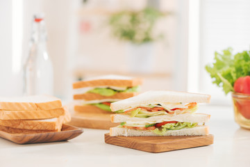 Close up portrait of a woman making sandwiches with vegetables on a cutting board