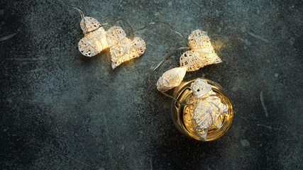 Beautiful heart-shaped fairy lights glowing inside glass jar. St. Valentine's Day mood
