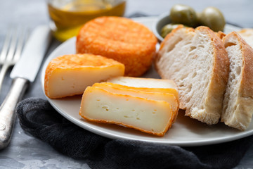 appetizer cheese with bread and olives on dish