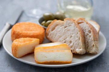 appetizer cheese with bread and olives on dish