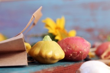 Bright fresh vegetables, fruits and flowers on a wooden table, healthy food