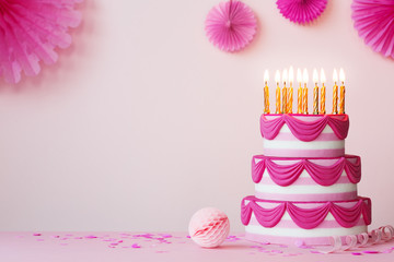 Birthday party with pink tiered birthday cake