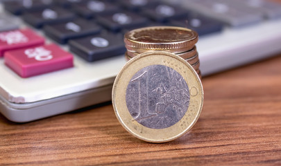 One euro close up on calculator background