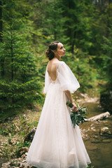 Fototapeta premium beautiful bride in white dress posing in nature
