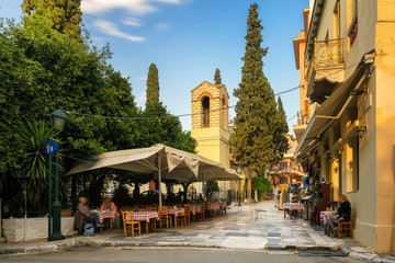 Old cozy street in Plaka district, cafes and restaurants in Athens, Greece - obrazy, fototapety, plakaty