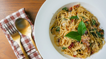 Spicy spaghetti with bacon and basil in the white dish,spicy spaghetti or sausage spaghetti.