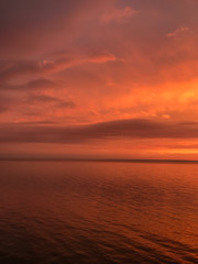 Naklejka na ściany i meble Red orange fire sunset at the sea