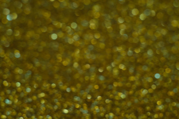 Abstract Christmast green bokeh background with shining defocus sparkles. Blurred glitters shimmering dust macro close up, copy space for text logo