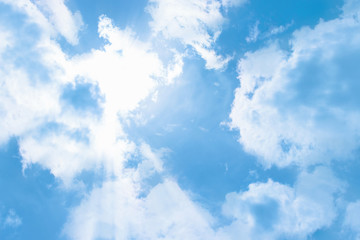 The rays of the sun break through the clouds, a clear blue sunny sky. Cloudscape Background Backdrop