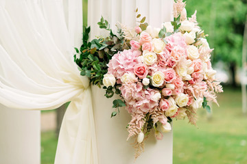 Decor with flower columns for the wedding ceremony. Festive decor. Soft focus.