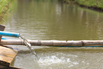 Water flows out of the pipe into canal.