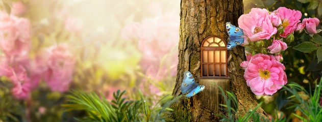 Enchanted fairy tale forest with magical shining window in hollow of fantasy pine tree elf house,...