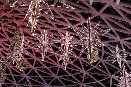 Illumination garland, luminous lights of purple golden stars under the dome, backdrop for design. Decoration of light bulbs chandelier lighting