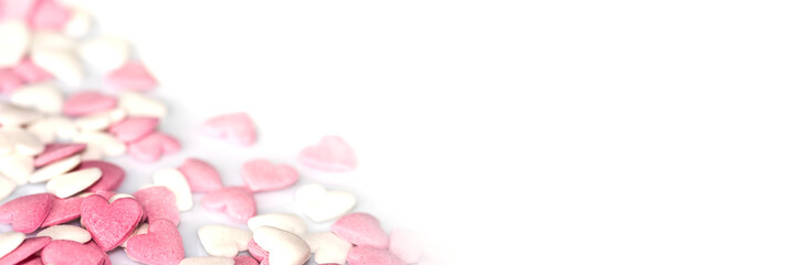 Obraz na płótnie Canvas Pink sugar hearts on white panoramic background