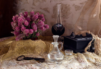 Still Life with an alcoholic beverage, a bouquet of wild flowers on the table close-up