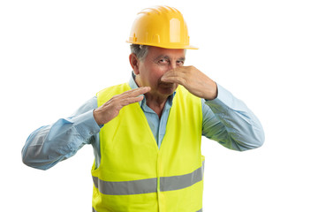 Builder holding nose with hand