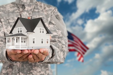 Military man Holding House Model, Real Estate Concept