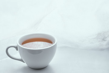 Simple white cup filled with tea