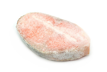 Frozen raw steak of atlantic salmon isolated on white background