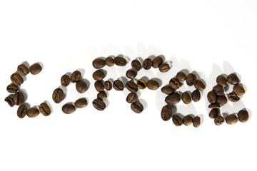 The inscription coffee made from ground coffee beans on a white background. Isolate