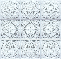 Blue ceramic tiles with floral and geometric patterns. Ligth texture for wall design. Seamless ornaments on concrete background.