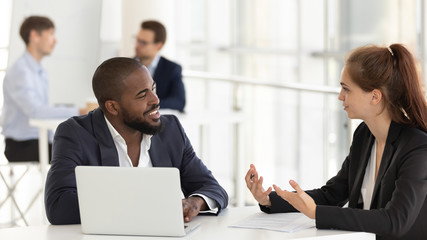 Confident female speak with african American male client