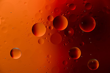 orange oil drops on water surface with effect duotone