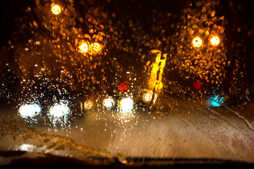 Raindrops on a car window with blurred background