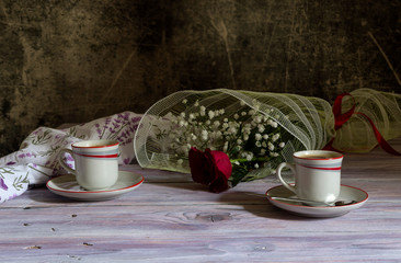 A cups of coffee and of rose