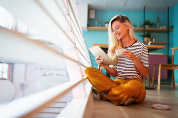 Portrait of pretty student or businesswoman in smart casual using digital tablet