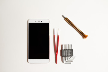 Repair of a smartphone in the service with a special tool. Smartphone repair tool on a white background.