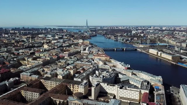 Aerial panorama of Saint Petersburg, the skyscraper Lakhta Center and the new stadium in the distance, Russia. Stock footage. Big city landscape on blue clear sky background.