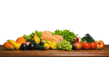Fresh crop of fruits and vegetables on a wooden table. Food isolated on a white background. Vegetarian food. Panoramic image