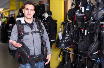 Active young male standing in new diving vest
