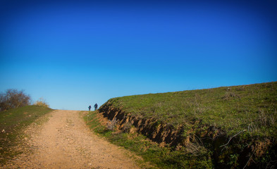 Fototapeta premium People walking through the countryside. Trekking.