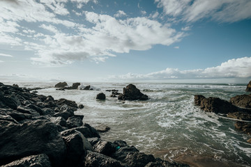 Obraz premium Rocky Beach landscape with cloudy sky