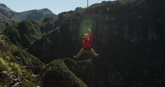 Young Caucasian man zip lining