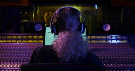 Female sound engineer working at a mixing desk - Powered by Adobe
