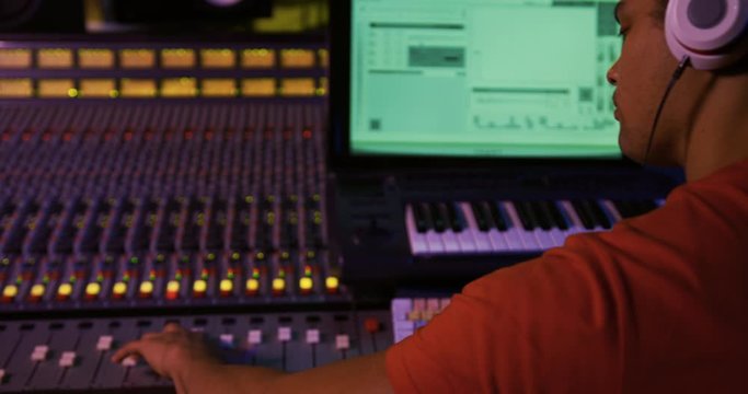 Male sound engineer working at a mixing desk