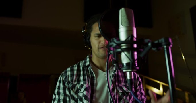 Male singer singing in a music studio