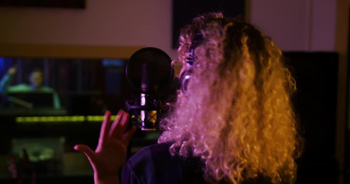 Female singer singing in a music studio