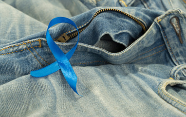 Blue ribbon for prostate cancer awareness on blue demin with copyspace