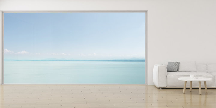 View of living room in minimal style with white sofa and small side table on wood laminate floor on sea view background. 3D rendering.	