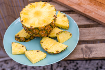 Pineapple slices on blue plate. Healthy food.
