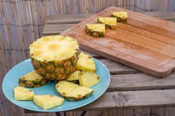 Pineapple slices on blue plate. Healthy food.