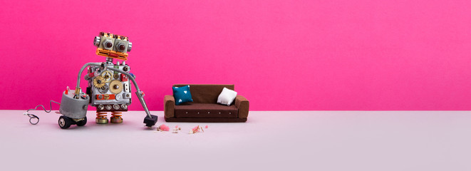 Robotic cleaning service. Funny autonomous robot uses a vacuum cleaner to clean the floor in a pink room with a sofa and a bunch of garbage on the floor. copy space