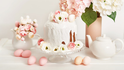 Easter orthodox sweet bread, kulich and colorful eggs with flowers. Holidays breakfast concept with copy space. Retro style. Easter greeting card template