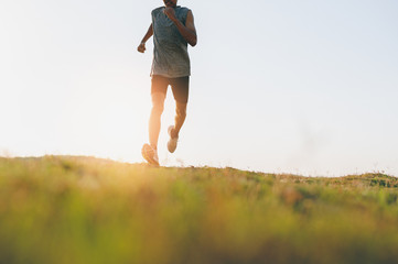Fototapeta premium Athlete runner feet running on road, Jogging at outdoors. Man running for exercise.Sports and healthy lifestyle concept.