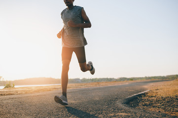 Athlete runner feet running on road, Jogging at outdoors. Man running for exercise.Sports and...