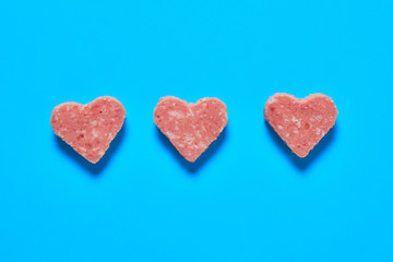 Three pieces of sausage in form of heart. Valentines day concept. Close-up